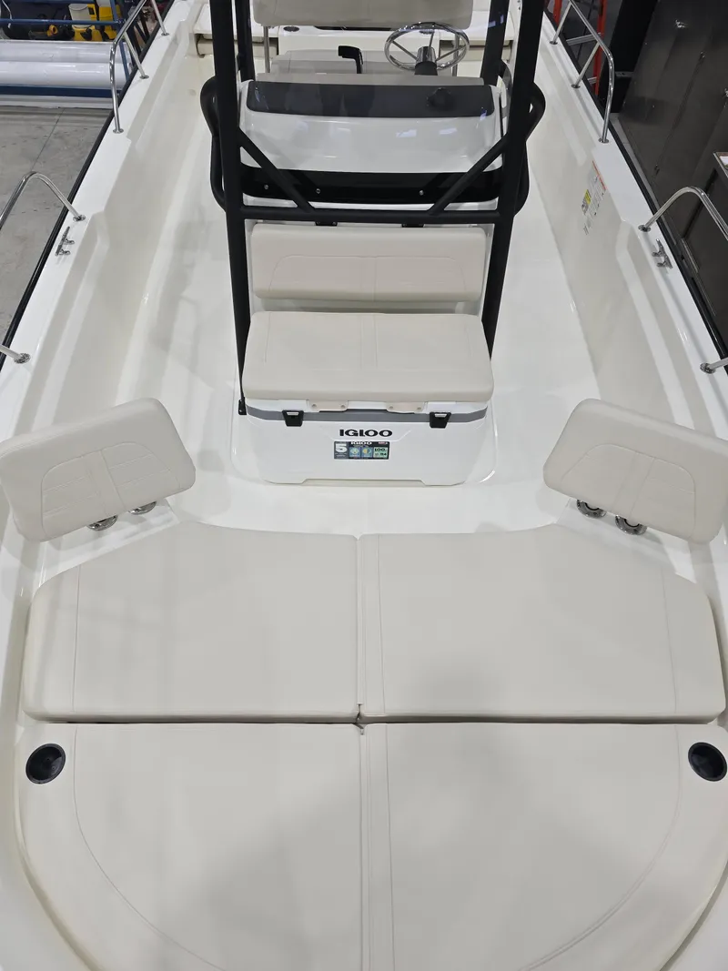 Slide: The Image of 2025 Boston Whaler 210 Montauk boat interior with seating and Igloo cooler. - 7