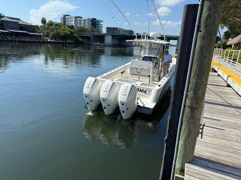 Slide: The Image of 2024 SeaVee 340Z boat with triple outboard engines docked on a sunny day. - 11