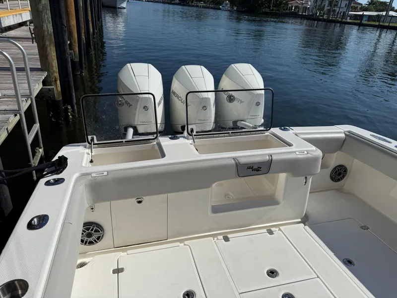 Slide: The Image of 2024 SeaVee 340Z boat with triple Mercury engines docked by the water. - 4