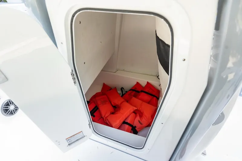 Slide: The Image of Storage compartment with life jackets on a 2025 Sea Fox 228 Commander boat. - 17