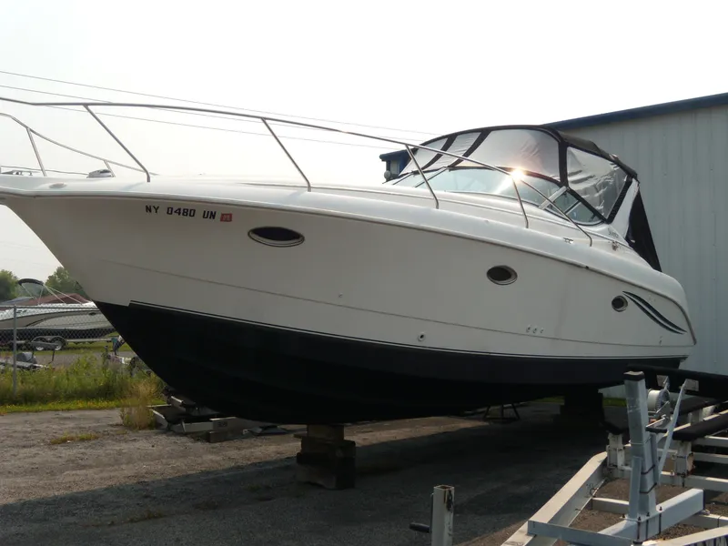The Image of 1996 Silverton 310 Express boat on dry dock, side view. - 1