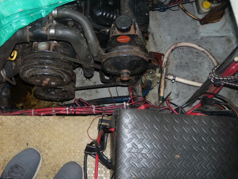 Slide: The Image of Engine compartment of a 1996 Silverton 310 Express boat with visible wiring and components. - 10