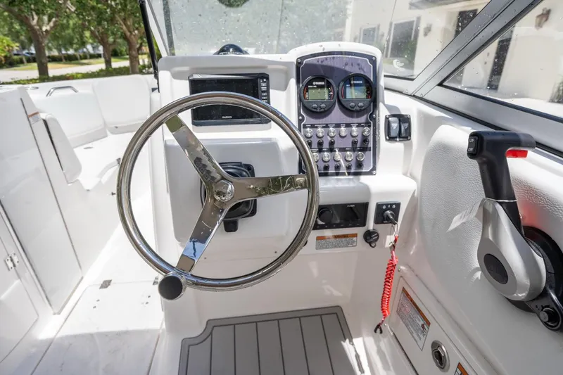 Slide: The Image of 2025 Sea Fox 228 Traveler boat cockpit with steering wheel and control panel. - 14