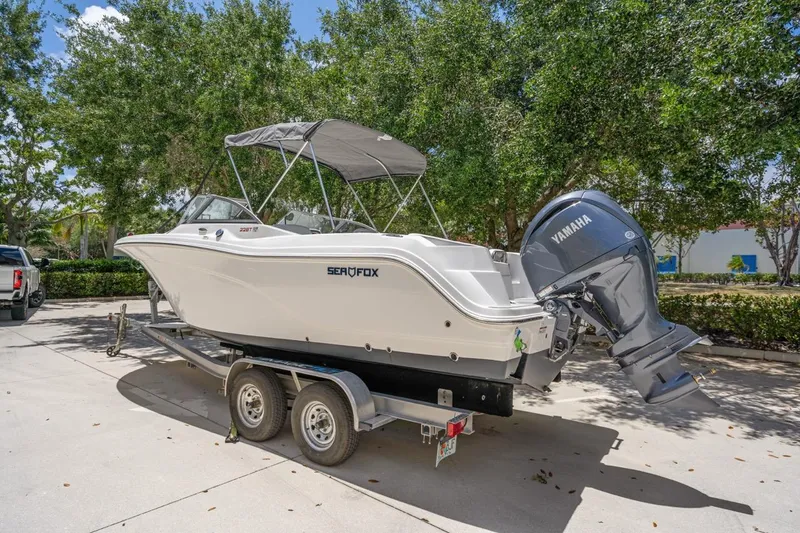 Slide: The Image of 2025 Sea Fox 228 Traveler boat on trailer with Yamaha outboard, parked outdoors. - 3