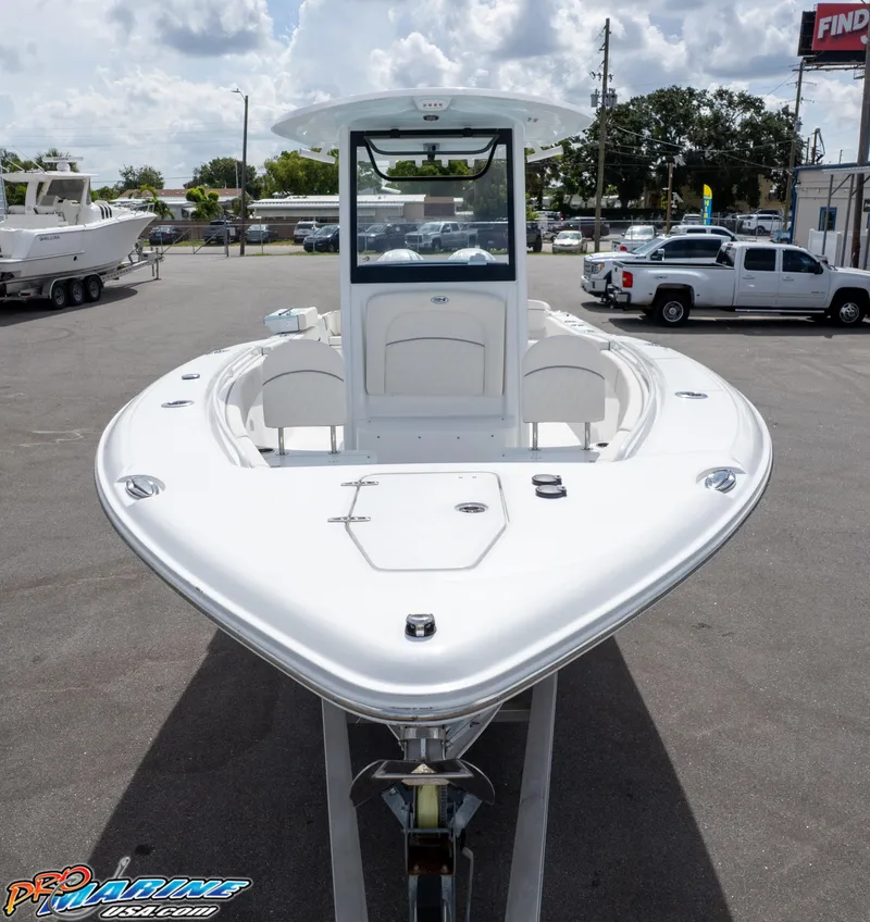 Slide: The Image of 2026 Sea Hunt Ultra 275 SE boat displayed in a parking lot under a cloudy sky. - 12