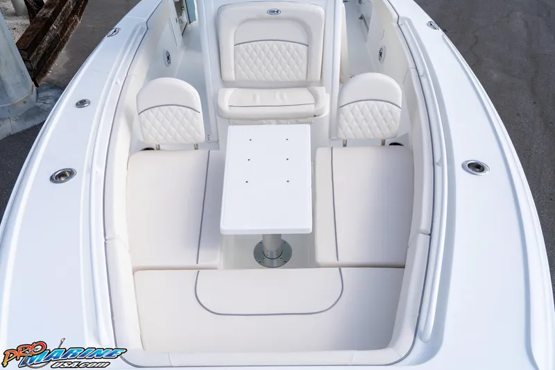 Slide: The Image of 2026 Sea Hunt Ultra 275 SE boat interior with white seating and table. - 13