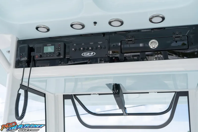 Slide: The Image of 2026 Sea Hunt Ultra 275 SE boat console with Garmin radio and control panel. - 17
