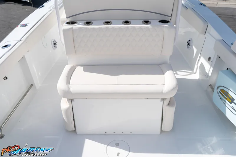 Slide: The Image of 2026 Sea Hunt Ultra 275 SE boat interior with cushioned seating and cup holders. - 21