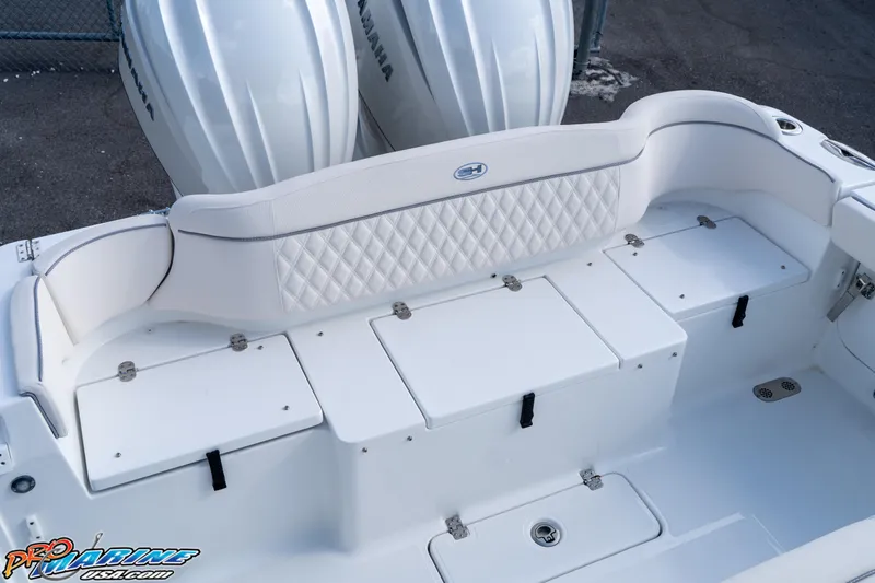 Slide: The Image of 2026 Sea Hunt Ultra 275 SE boat with white seating and storage compartments. - 22