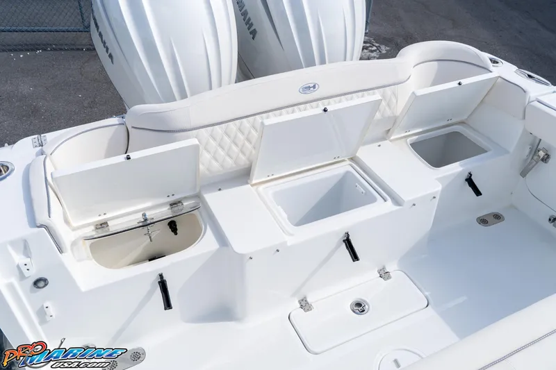 Slide: The Image of 2026 Sea Hunt Ultra 275 SE boat with open storage compartments and Yamaha engines. - 23