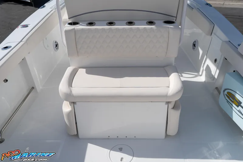 Slide: The Image of 2026 Sea Hunt Ultra 275 SE boat seating area with cup holders and storage. - 24