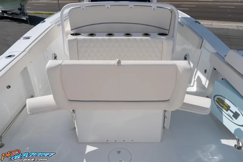 Slide: The Image of 2026 Sea Hunt Ultra 275 SE boat interior with white seating and rod holders. - 26