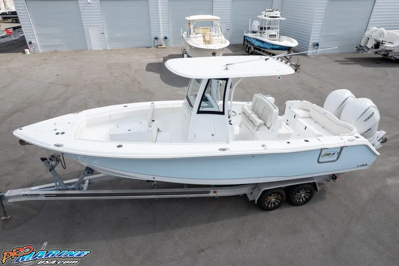 Slide: The Image of 2026 Sea Hunt Ultra 275 SE boat on trailer, parked in marina lot. - 8