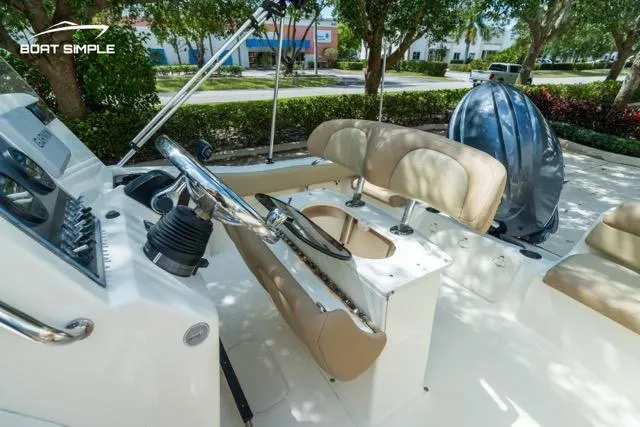 Slide: The Image of 2024 Scout 195 Sportfish boat interior with steering console and seating. - 5