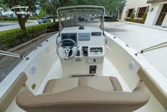 Slide: The Image of 2024 Scout 195 Sportfish boat interior with steering wheel and Garmin navigation system. - 8