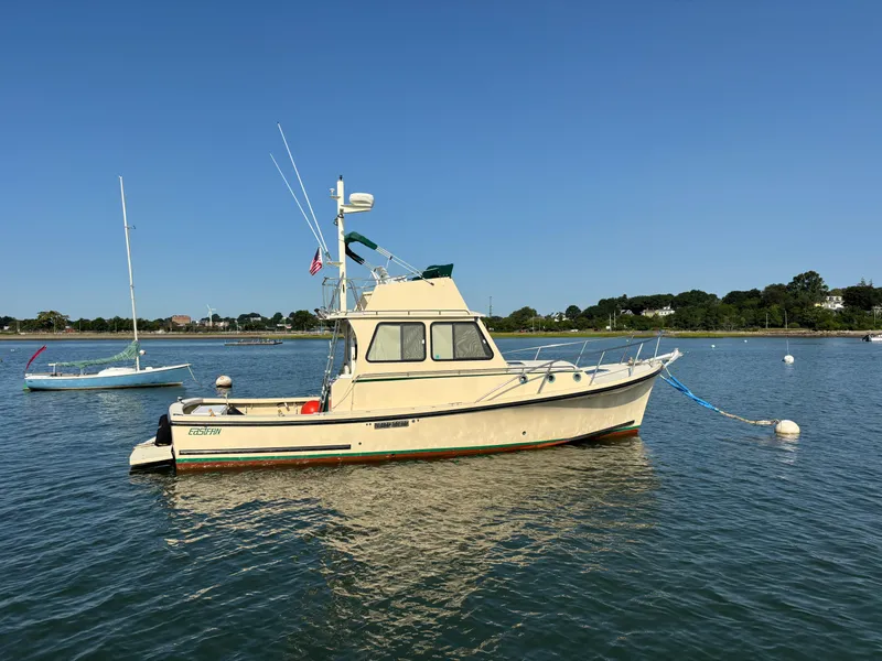 Slide: The Image of Eastern Casco Bay 31 boat from 2000 moored on calm water under clear blue sky. - 0