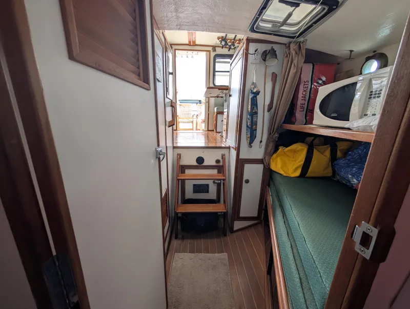 Slide: The Image of Interior of 2000 Eastern Casco Bay 31 boat with bunk, microwave, and storage. - 16