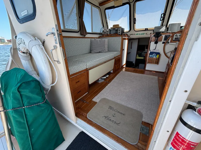 Slide: The Image of Interior of 2000 Eastern Casco Bay 31 boat with cozy seating and nautical decor. - 4