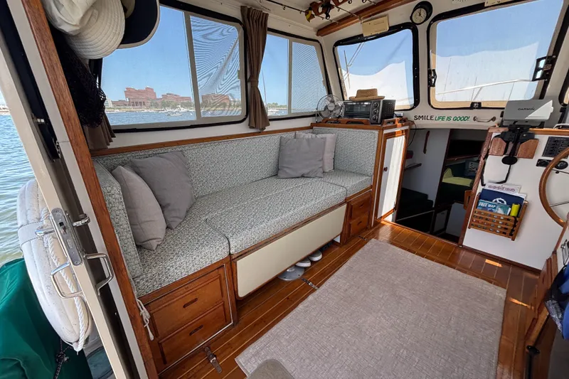 Slide: The Image of Interior of a 2000 Eastern Casco Bay 31 boat with cozy seating and nautical decor. - 5