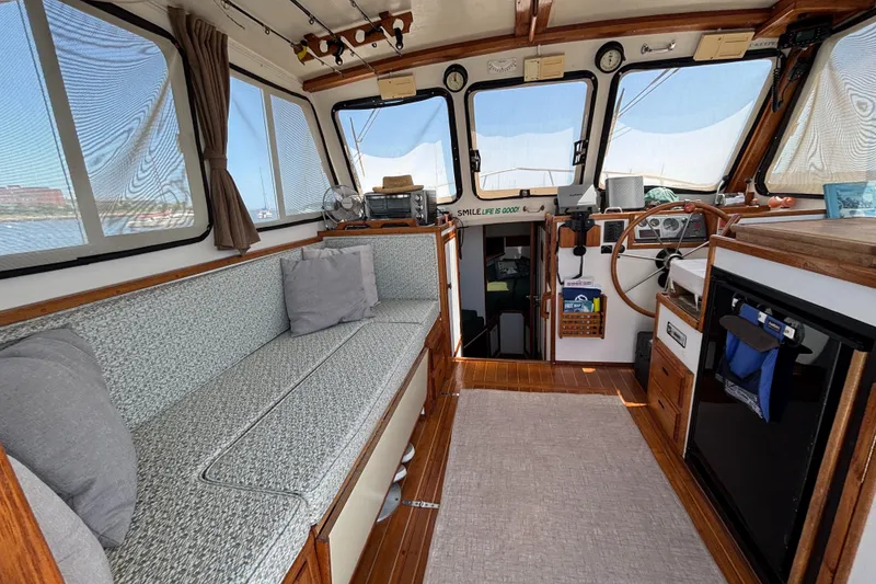 Slide: The Image of Interior of 2000 Eastern Casco Bay 31 boat with cozy seating and wooden accents. - 6