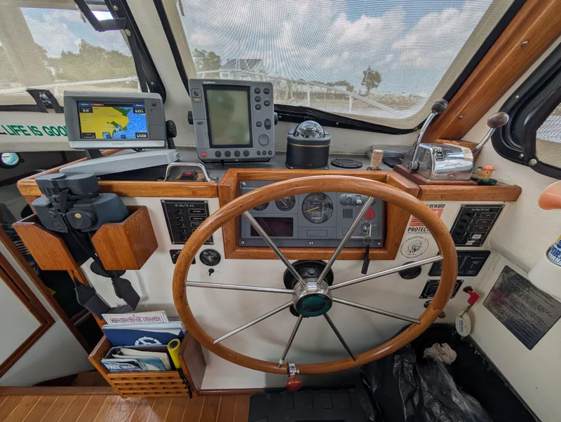 Slide: The Image of Interior helm of 2000 Eastern Casco Bay 31 boat with navigation equipment and wooden steering wheel. - 9