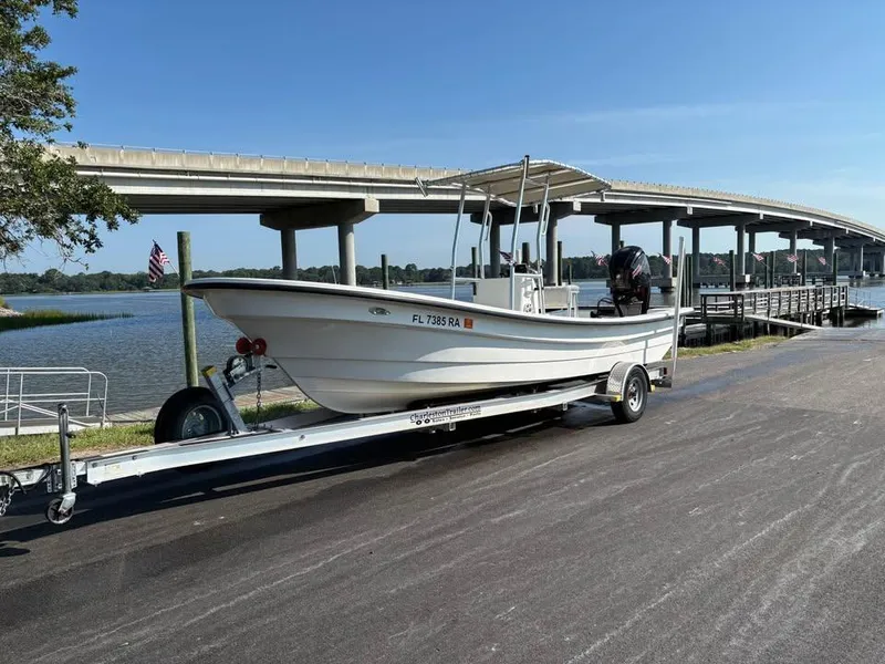 The Image of 2016 American Panga boat on trailer near waterfront and bridge. - 1