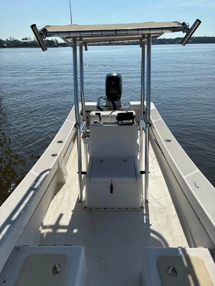 Slide: The Image of 2016 Panga American Panga boat on calm water, featuring a central console and canopy. - 11