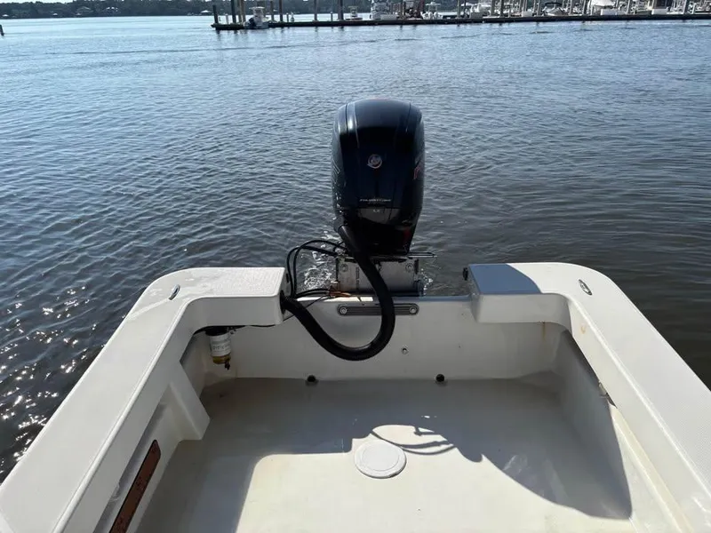 Slide: The Image of 2016 American Panga boat with outboard motor on calm water near a marina. - 9