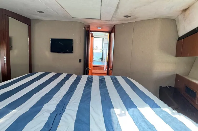 Slide: The Image of Interior of 2013 Fairline Squadron 42 yacht with striped bedding and wall-mounted TV. - 12