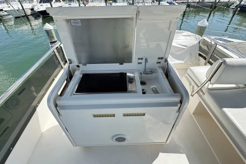 Slide: The Image of Outdoor kitchenette on 2013 Fairline Squadron 42 yacht, featuring grill and sink. - 18