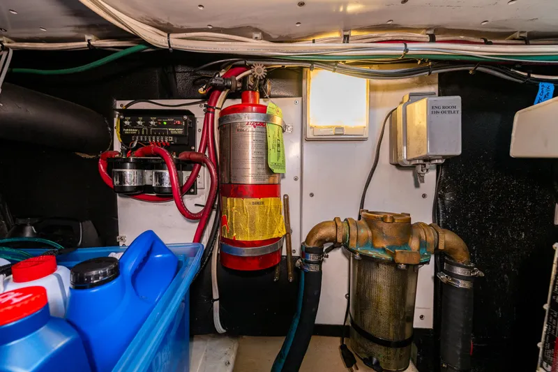 Slide: The Image of Engine room of a 2000 Nordic Tug 32 with fire extinguisher and electrical components. - 23
