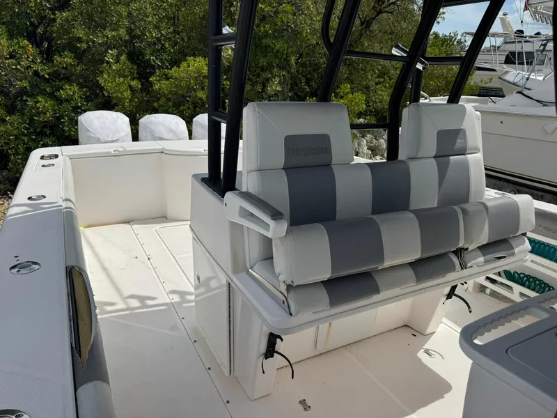Slide: The Image of 2016 Everglades 355 Tournament boat interior with cushioned seating and fishing rod holders. - 10