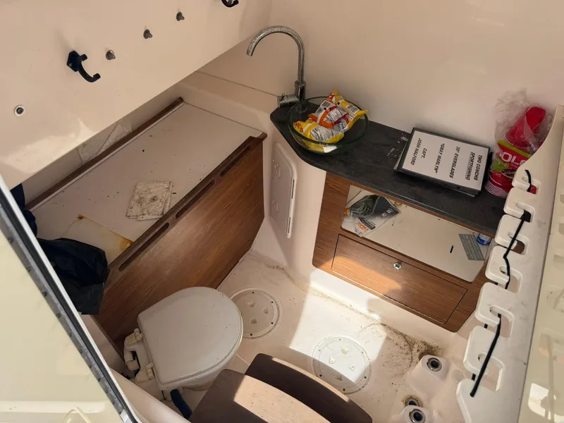 Slide: The Image of Interior of 2016 Everglades 355 Tournament boat with compact bathroom and storage. - 13