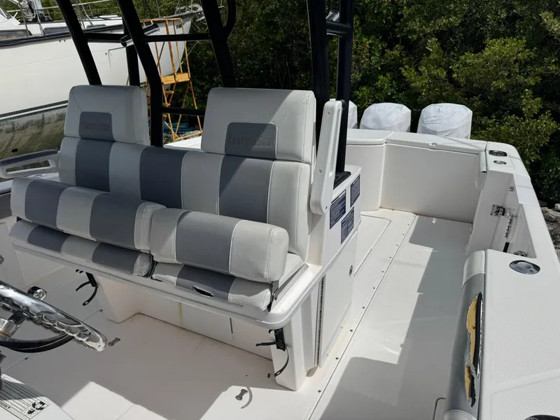 Slide: The Image of 2016 Everglades 355 Tournament boat interior with striped seating and steering wheel. - 14