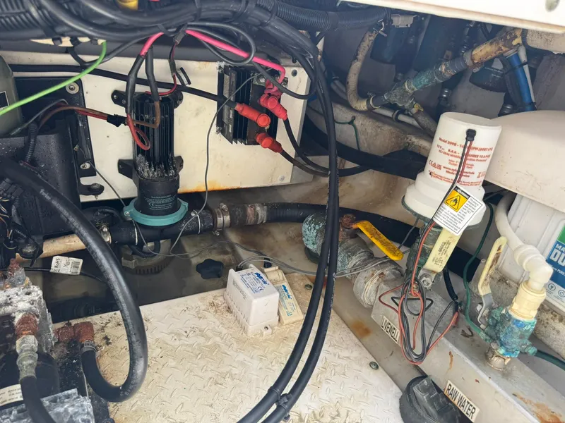 Slide: The Image of Engine compartment of a 2016 Everglades 355 Tournament boat, showing wiring and plumbing components. - 18