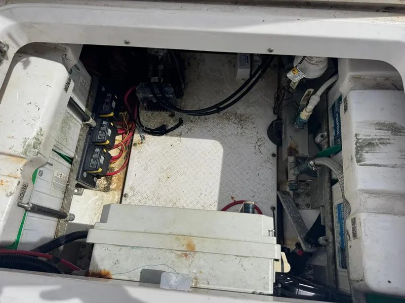 Slide: The Image of Engine compartment of a 2016 Everglades 355 Tournament boat, showing batteries and wiring. - 19