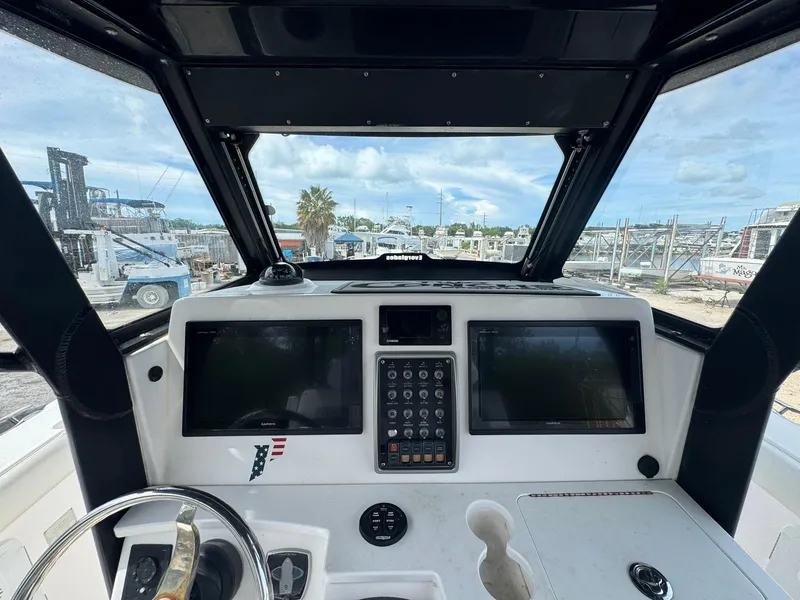 Slide: The Image of 2016 Everglades 355 Tournament boat dashboard with dual Garmin displays and control panel. - 24