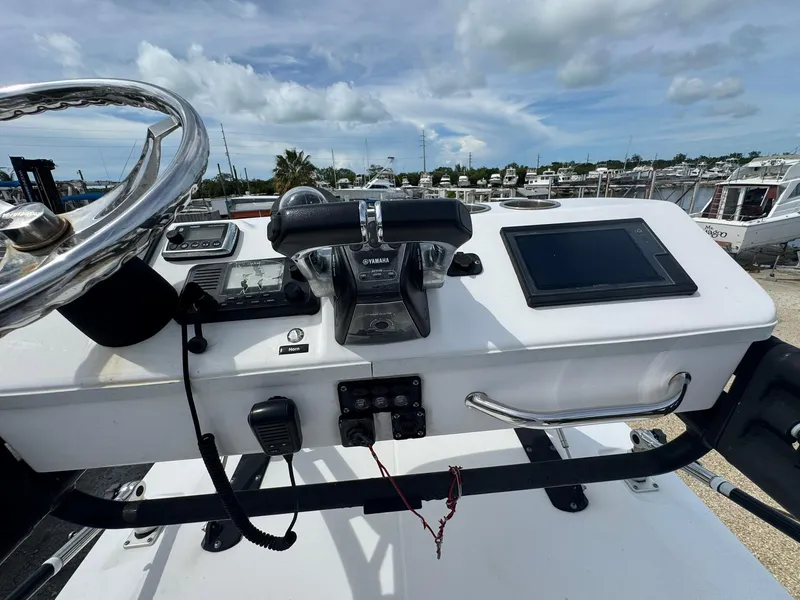 Slide: The Image of Control panel of 2016 Everglades 355 Tournament boat with steering wheel and navigation equipment. - 26