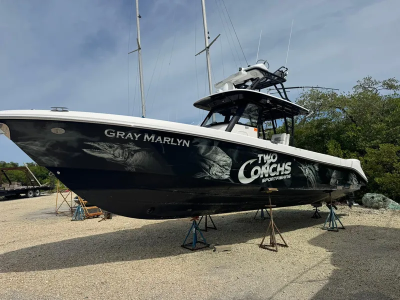 Slide: The Image of 2016 Everglades 355 Tournament boat on stands, featuring "Gray Marlyn" and "Two Conchs Sportfishing" graphics. - 3