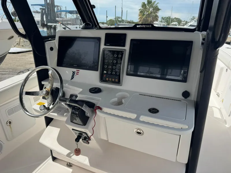 Slide: The Image of 2016 Everglades 355 Tournament boat dashboard with steering wheel and navigation screens. - 9