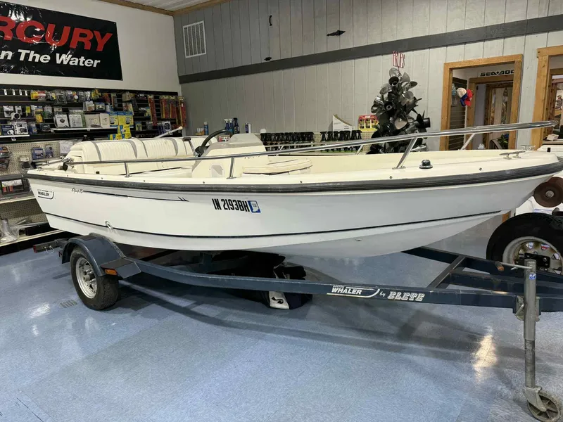 Slide: The Image of 1997 Boston Whaler Rage 15 boat on trailer in showroom. - 1