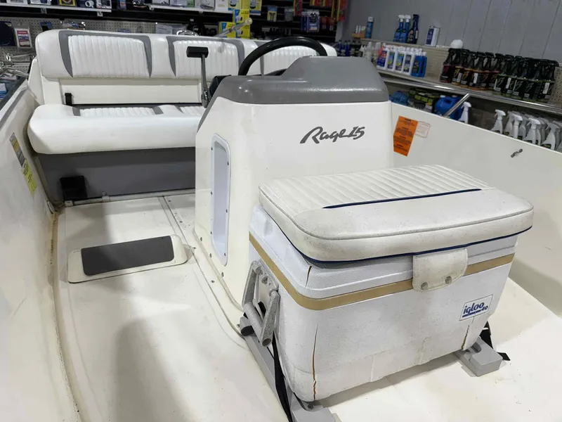 Slide: The Image of 1997 Boston Whaler Rage 15 boat interior with seating and cooler. - 11