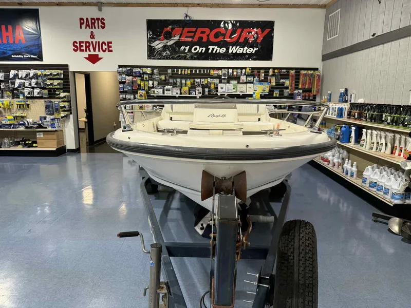 Slide: The Image of 1997 Boston Whaler Rage 15 boat displayed in a marine parts store. - 16