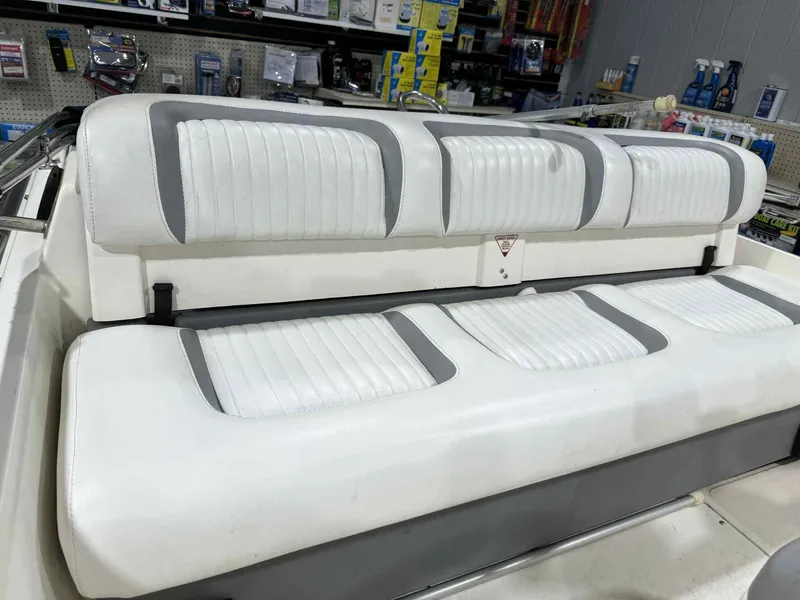 Slide: The Image of 1997 Boston Whaler Rage 15 boat interior with white and gray seating. - 4