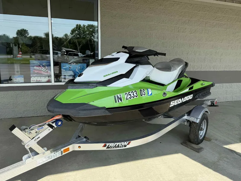 Slide: The Image of 2013 Sea-Doo GTI SE 130 jet ski on a trailer, parked outside a building. - 1