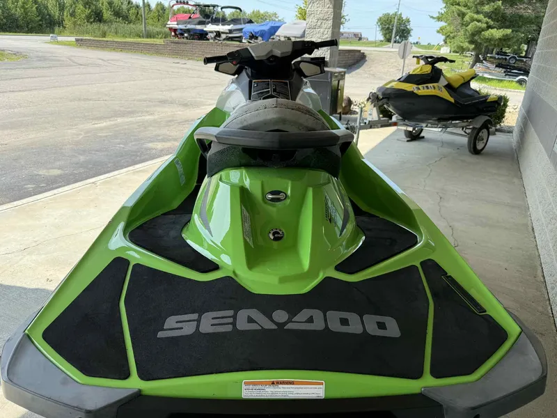 Slide: The Image of 2013 Sea-Doo GTI SE 130 in green, parked outdoors. - 2