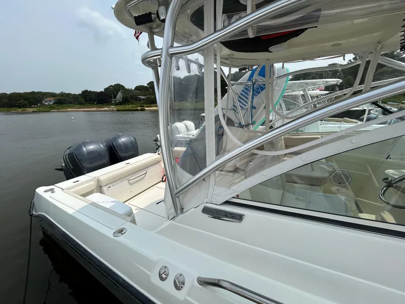 Slide: The Image of 2011 Hydra-Sports 3000 VX boat stern with motor and docked alongside another vessel. - 21