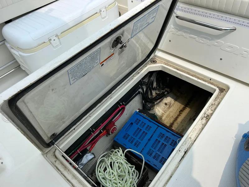 Slide: The Image of Open storage compartment on 2011 Hydra-Sports 3000 VX boat with equipment and rope. - 28