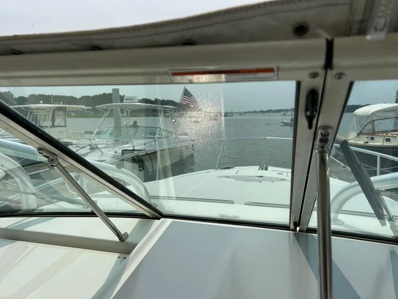 Slide: The Image of 2011 Hydra-Sports 3000 VX boat view through windshield, docked with other boats nearby. - 29