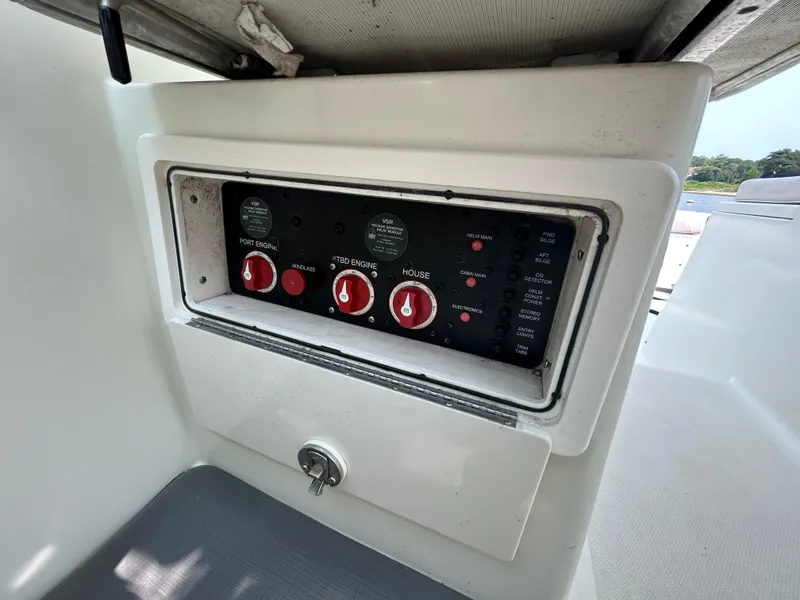 Slide: The Image of Control panel of a 2011 Hydra-Sports 3000 VX boat with red switches. - 31